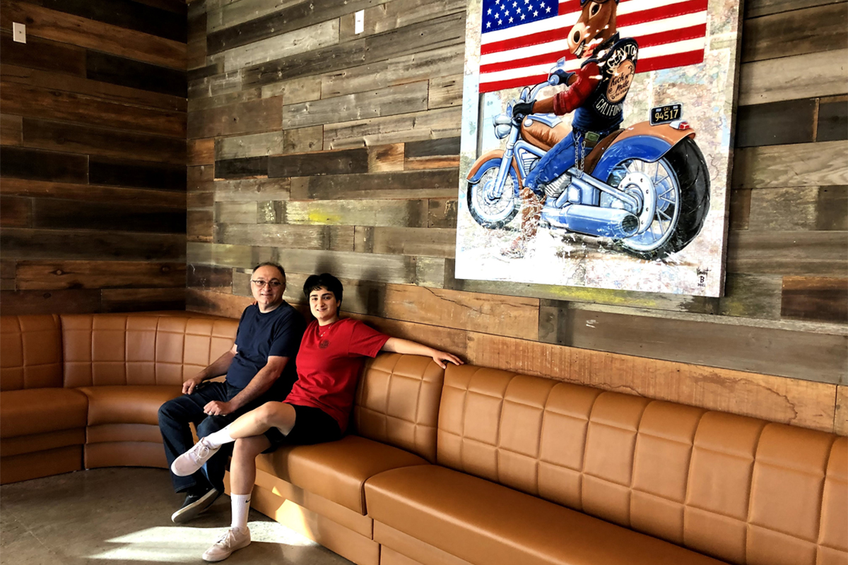 Kam's Furniture & Upholstery founder with a custom-built restaurant booth